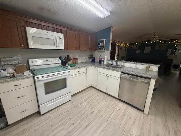 a kitchen with a stove cabinets and wooden floor
