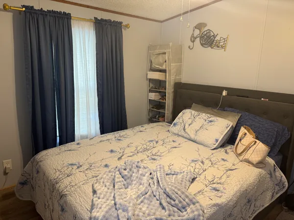 a bedroom with a bed and a window