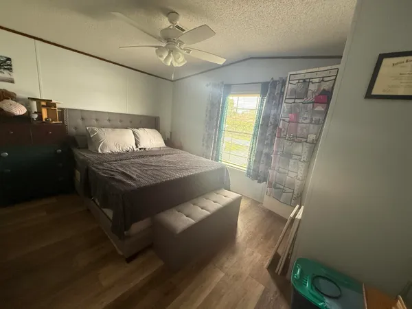 a bedroom with a bed and a chandelier