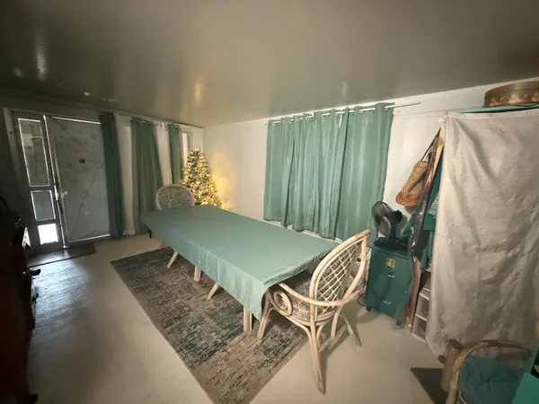 a balcony with chairs and a rug
