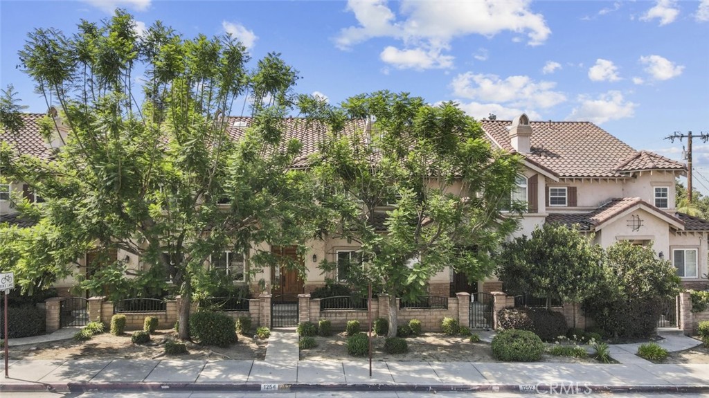 a view of a house with a yard and sitting area