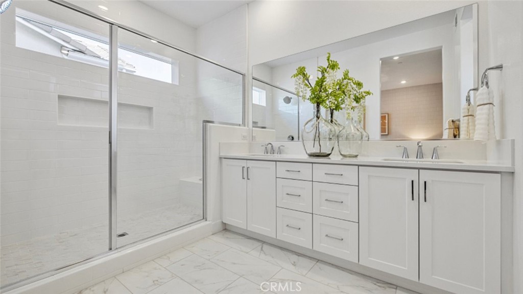 110 Seep Irvine, CA 92618 - Photo 12 of 33 a bathroom with a granite countertop sink a mirror and a shower