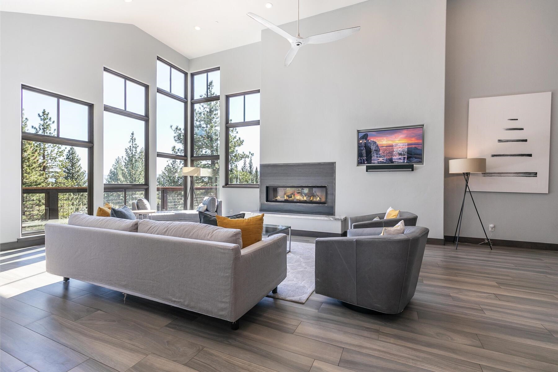 a living room with furniture a flat screen tv and wooden floor