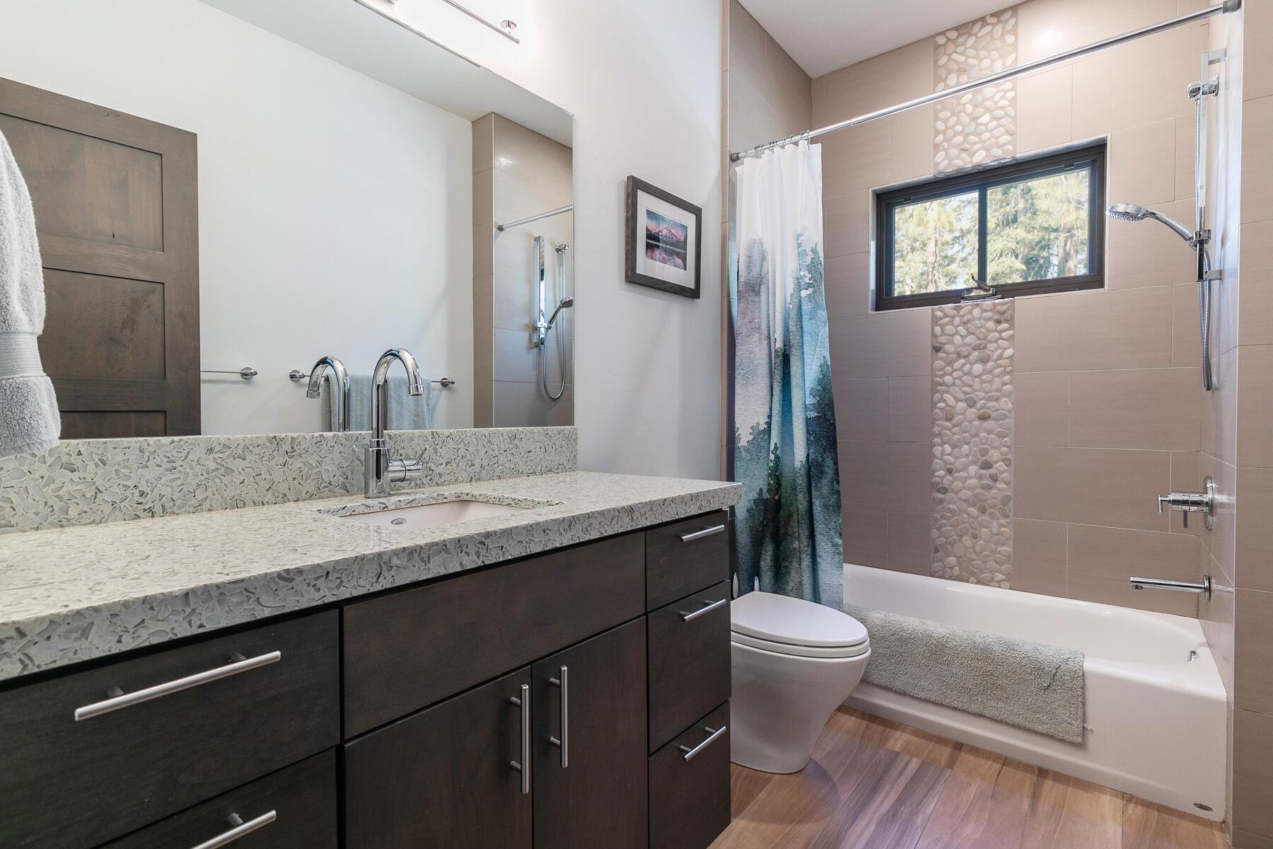 11863 Coburn Drive Truckee, CA 96161 - Photo 17 of 21 a bathroom with a granite countertop sink toilet a large mirror and shower