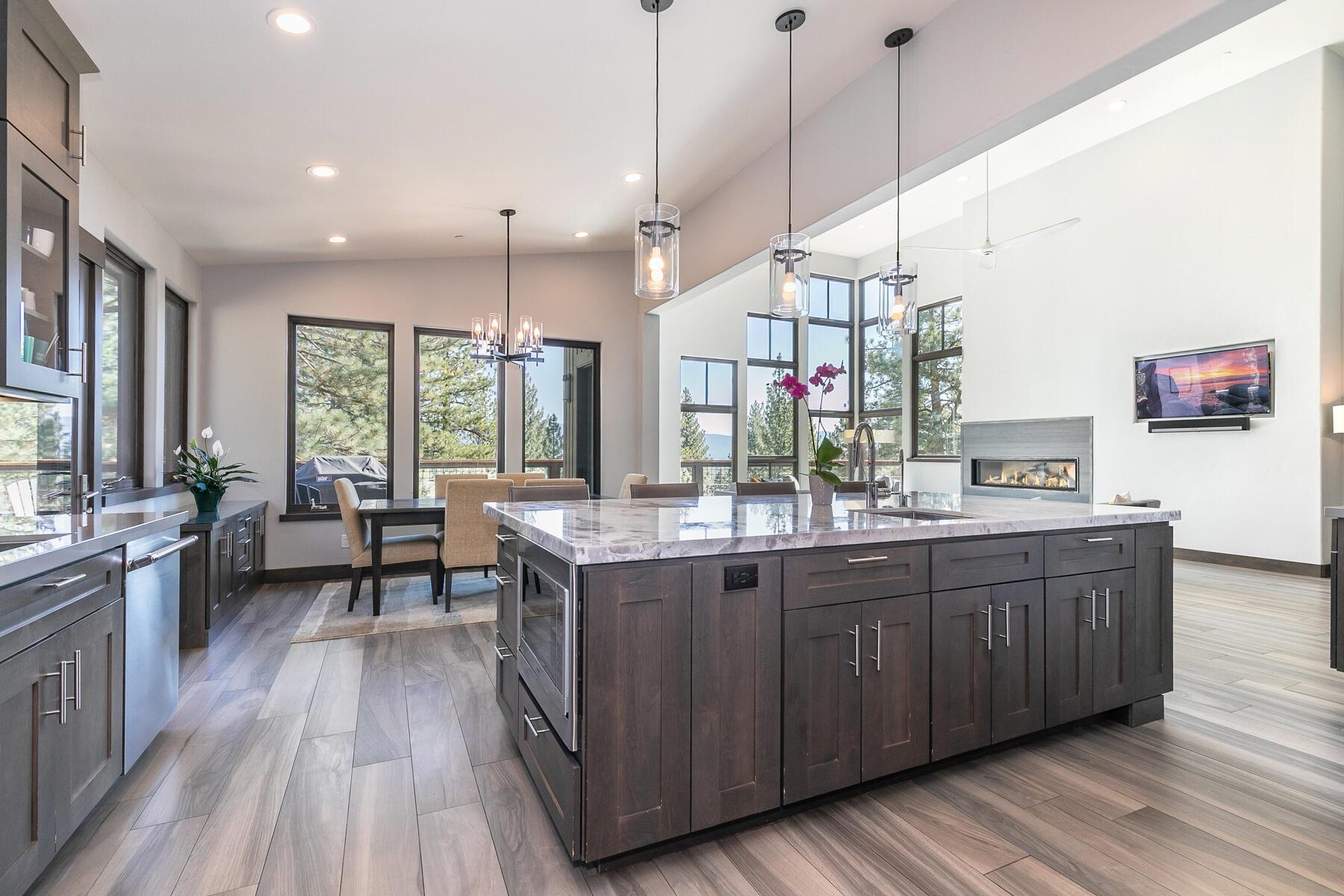 11863 Coburn Drive Truckee, CA 96161 - Photo 9 of 21 a kitchen with stainless steel appliances granite countertop wooden floors stove sink and cabinets