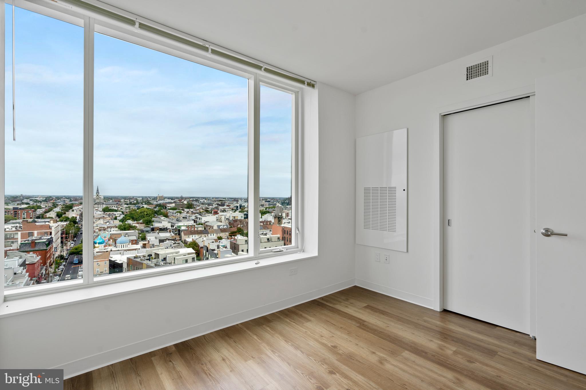 569 North 5th Street, Unit 902 Philadelphia, PA 19123 - Photo 8 of 49 an empty room with wooden floor and windows