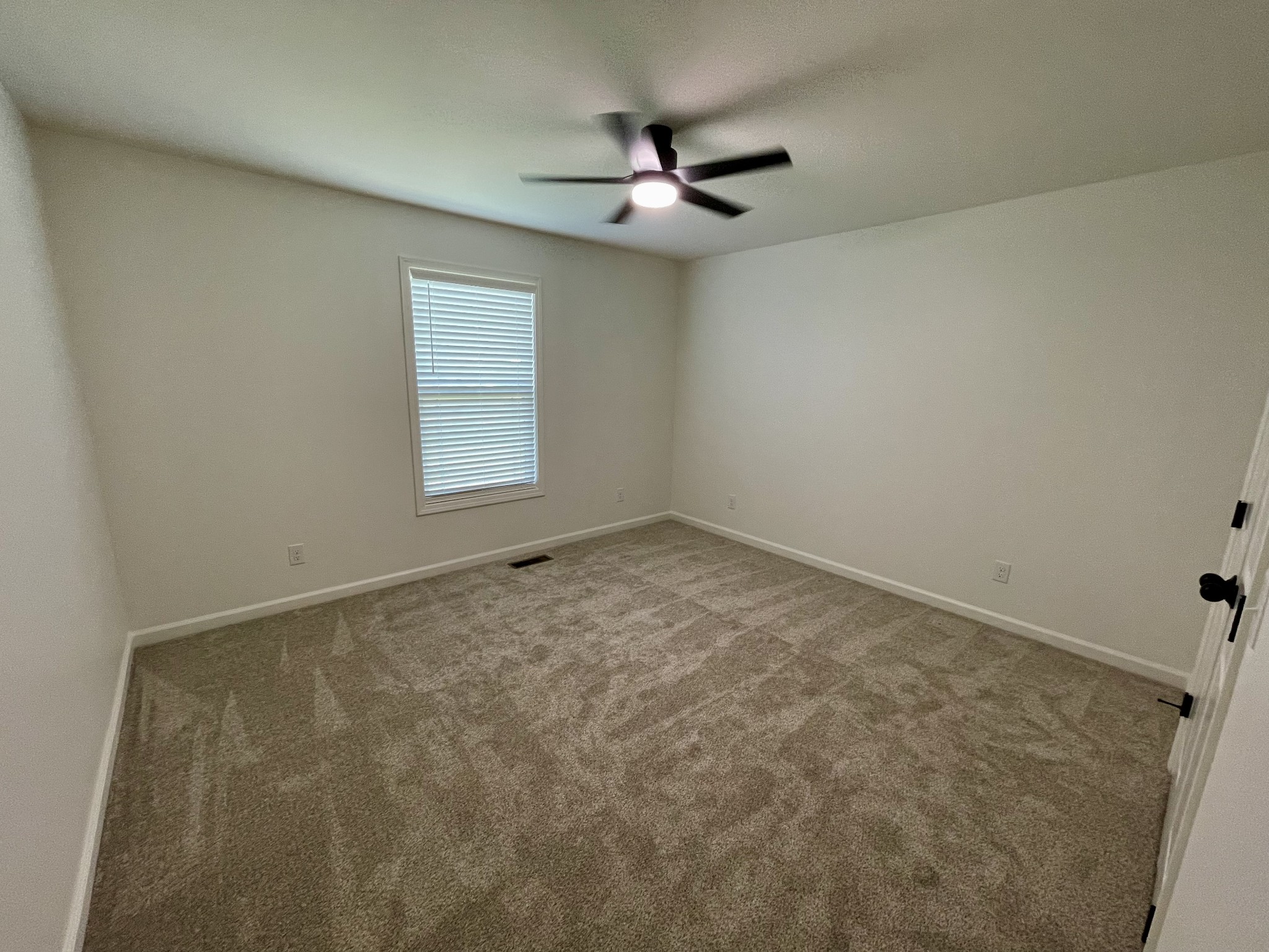 104 Donald Road Lafayette, TN 37083 - Photo 21 of 22 an empty room with a window and a fan