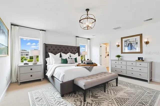 a bed room with a bed and a chandelier