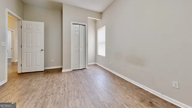 a view of an empty room and wooden floor