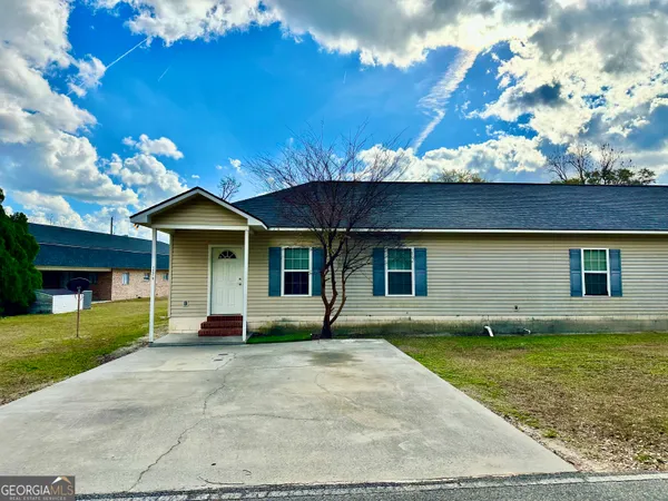 a front view of a house with garden
