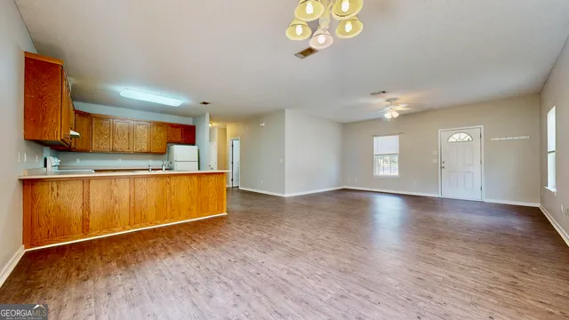 a view of a kitchen with a sink cabinets and wooden floor
