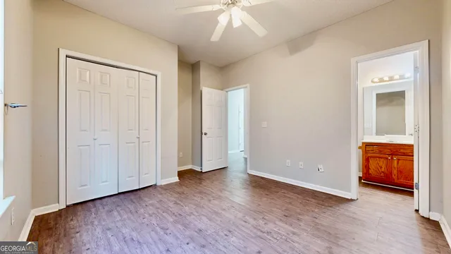 a view of an empty room and bathroom with a sink