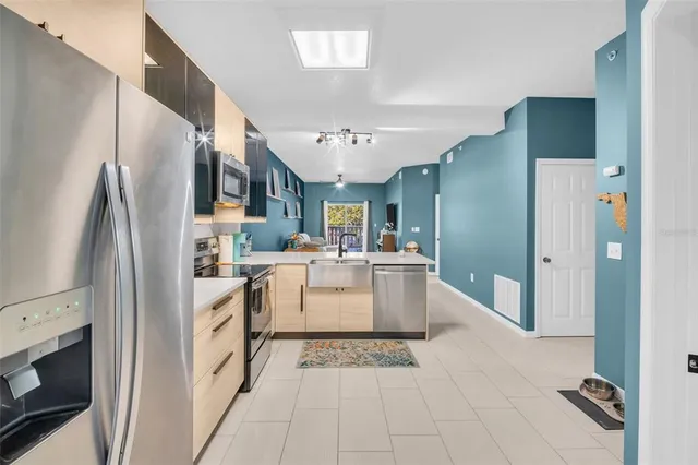 a kitchen with a refrigerator a sink and dishwasher
