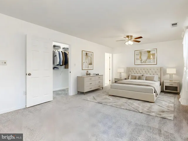 a bathroom with a sink a toilet and a large mirror