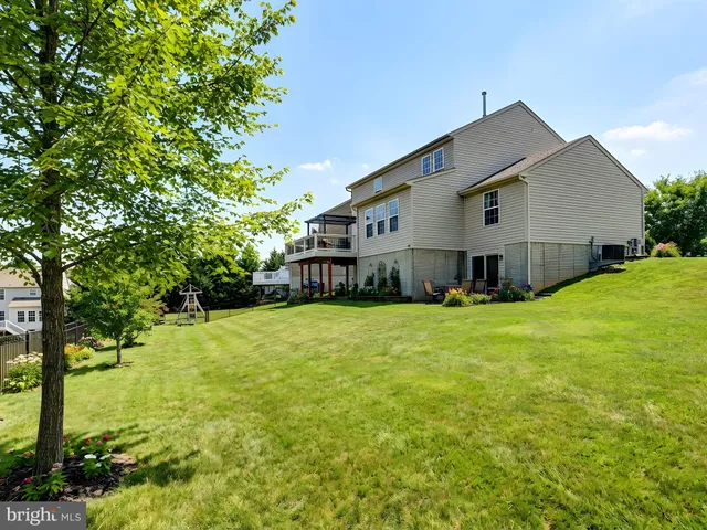 a front view of a house with a yard table and chairs