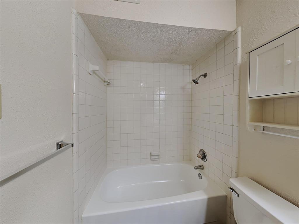 9811 Walnut Street, Unit 108 Dallas, TX 75243 - Photo 11 of 12 a bathroom with a bathtub