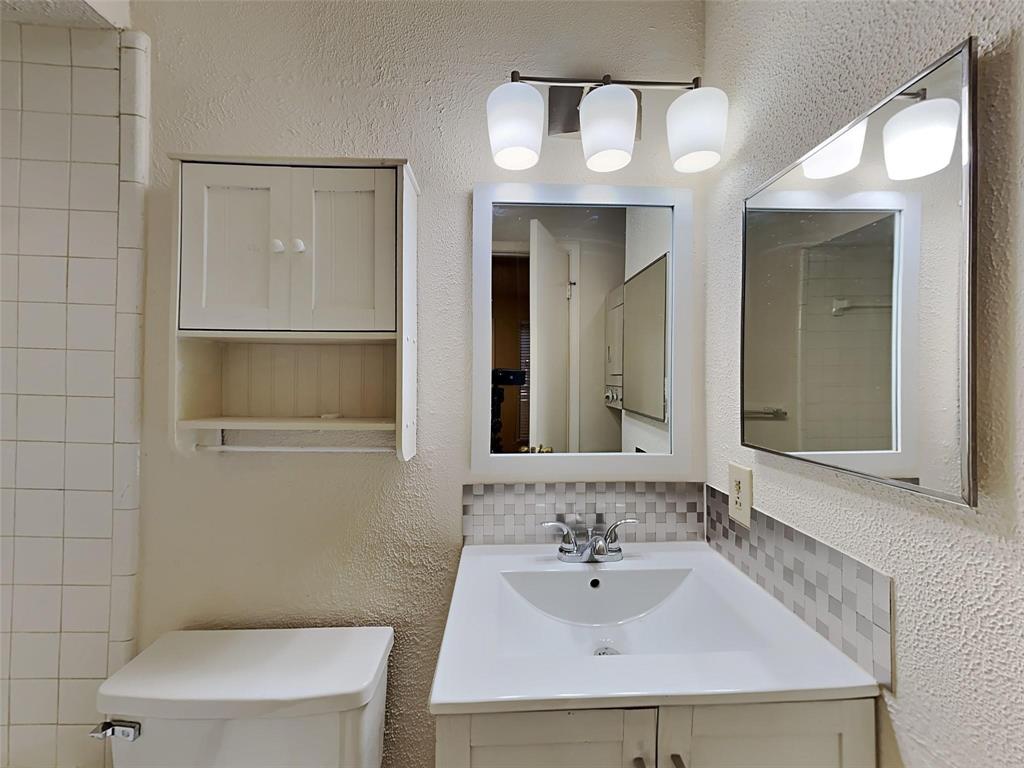 9811 Walnut Street, Unit 108 Dallas, TX 75243 - Photo 12 of 12 a bathroom with a sink and a mirror