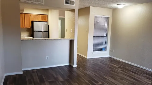 a view of a room with wooden floor and gate