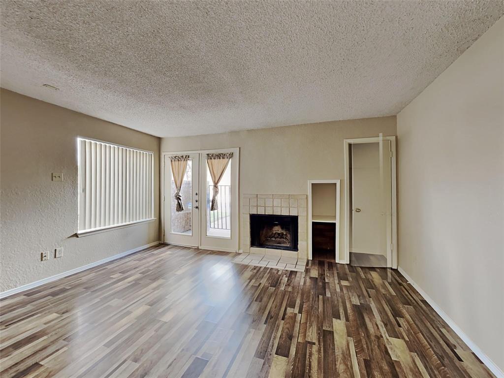 9811 Walnut Street, Unit 108 Dallas, TX 75243 - Photo 6 of 12 wooden floor fireplace and windows in an empty room