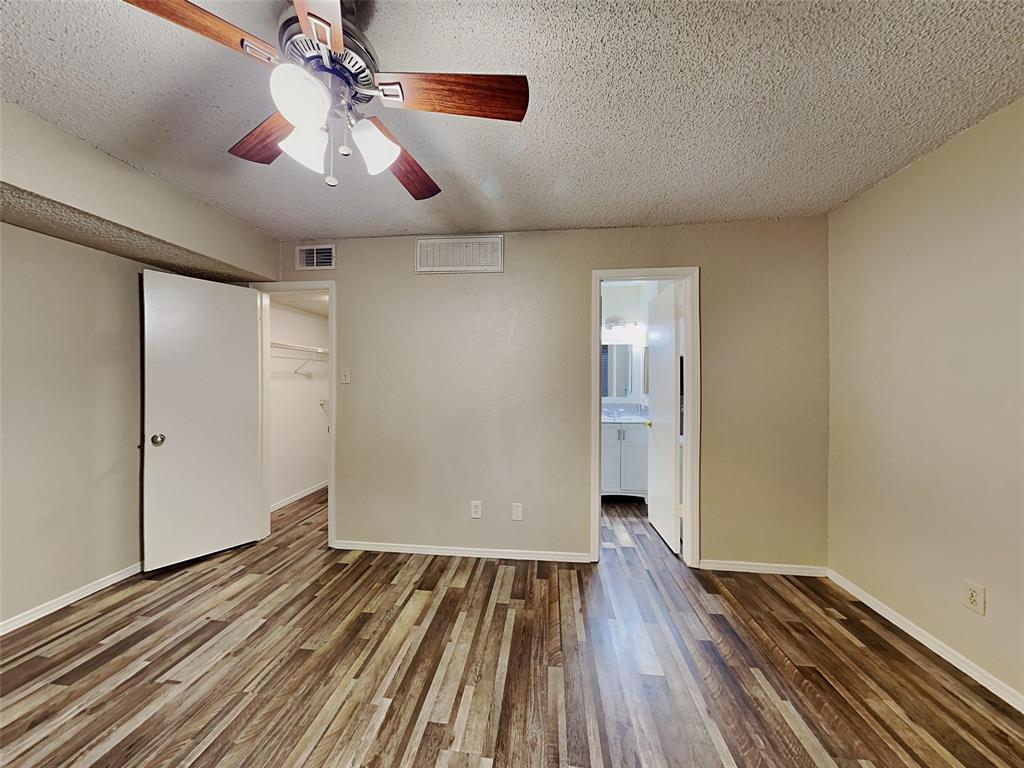 9811 Walnut Street, Unit 108 Dallas, TX 75243 - Photo 8 of 12 a view of a room with wooden floor staircase and a ceiling fan