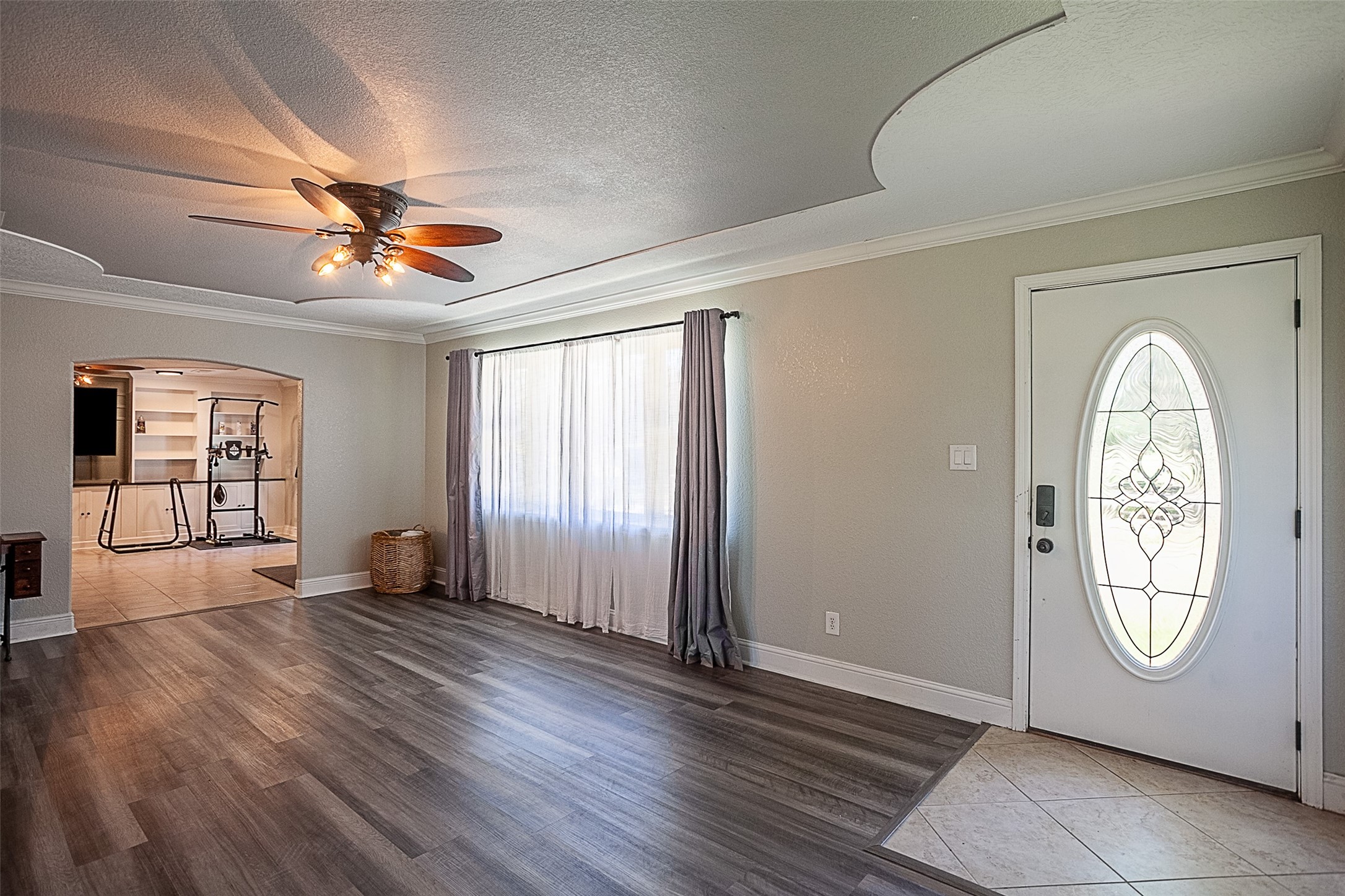 120 Mayflower Street Bridge City, TX 77611 - Photo 3 of 27 an empty room with window ceiling fan and wooden floor