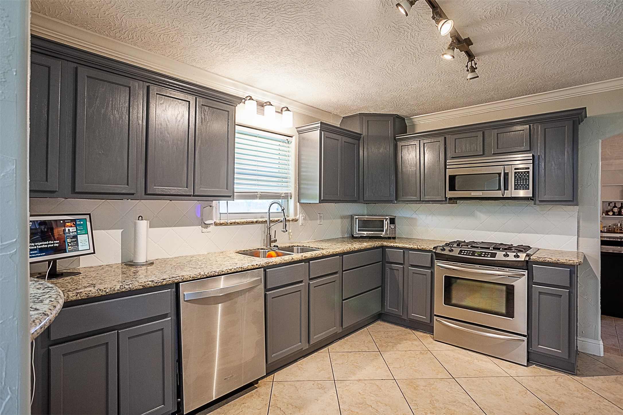 120 Mayflower Street Bridge City, TX 77611 - Photo 10 of 27 a kitchen with stainless steel appliances granite countertop a sink dishwasher stove and oven