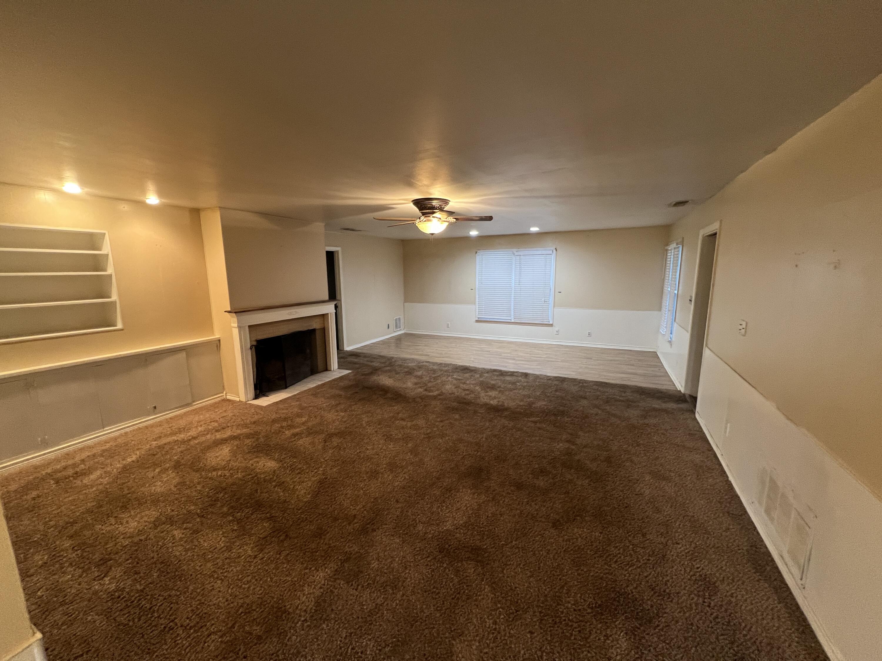 203 Northeast Alpine Plainview, TX 79072 - Photo 2 of 15 a view of a livingroom with a fireplace