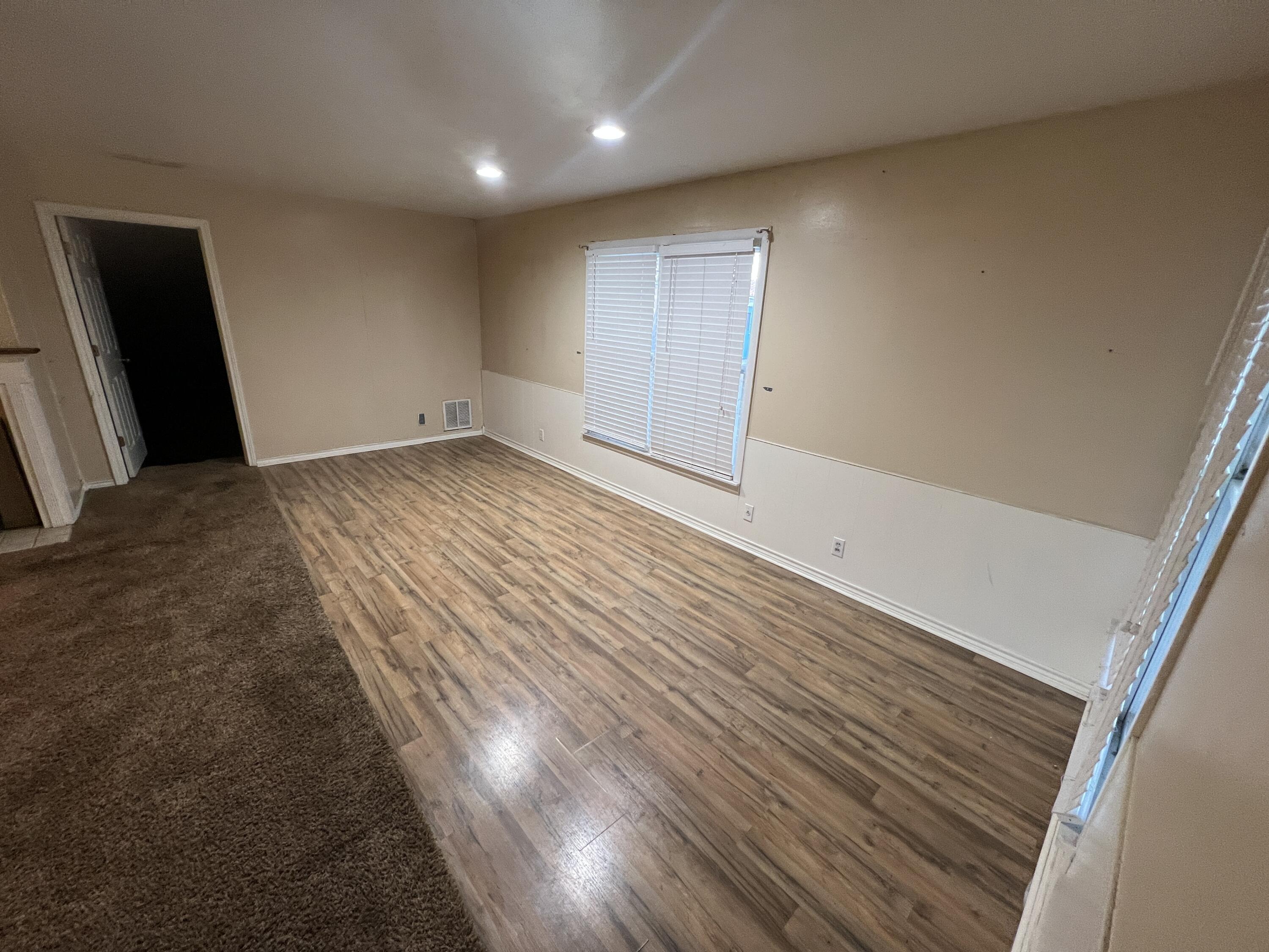 203 Northeast Alpine Plainview, TX 79072 - Photo 4 of 15 a view of empty room with wooden floor