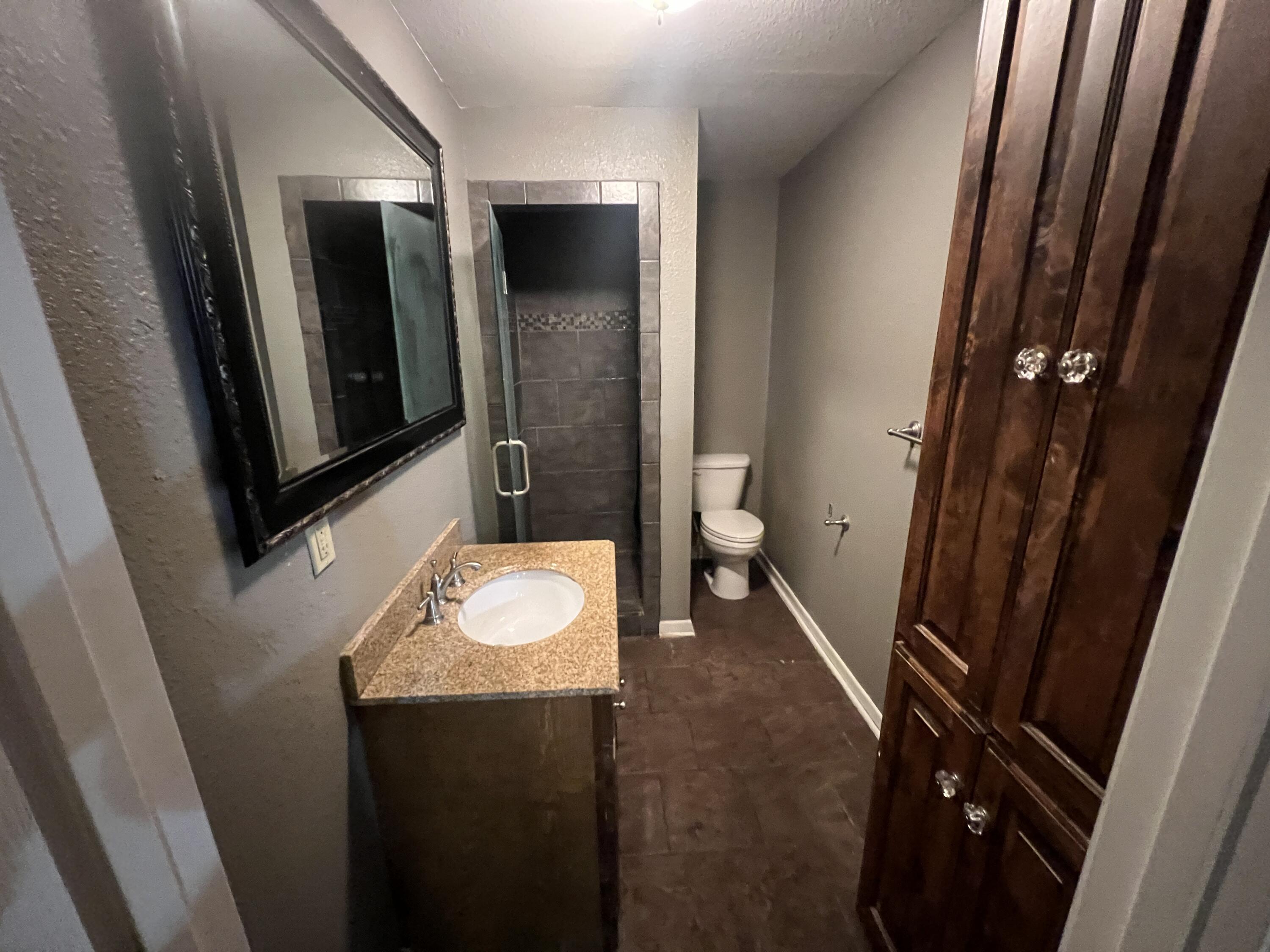 203 Northeast Alpine Plainview, TX 79072 - Photo 9 of 15 a bathroom with a sink and mirror with toilet