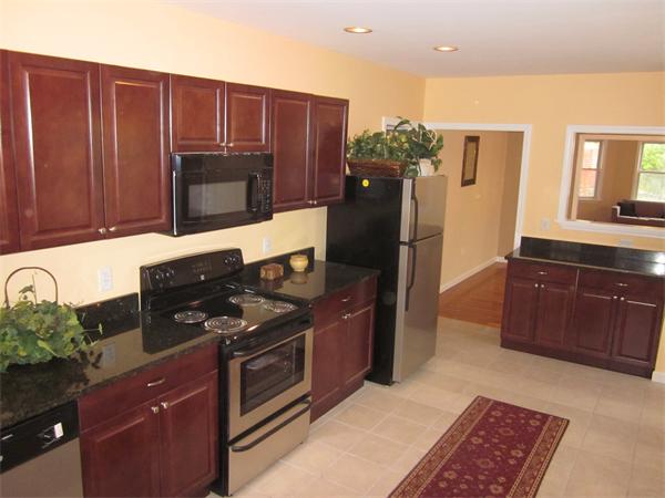 93 Rossmore Road, Unit 3 Boston, MA 02130 - Photo 1 of 11 a kitchen with stainless steel appliances granite countertop a stove a refrigerator and a microwave