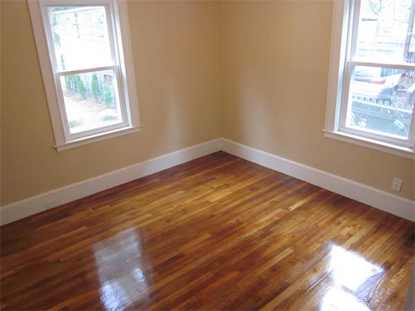 93 Rossmore Road, Unit 3 Boston, MA 02130 - Photo 3 of 11 a view of an empty room with wooden floor and a window