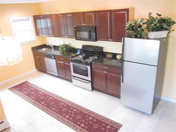 93 Rossmore Road, Unit 3 Boston, MA 02130 - Photo 4 of 11 a kitchen with stainless steel appliances granite countertop a refrigerator a stove a sink and a microwave