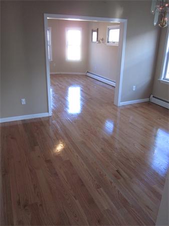 93 Rossmore Road, Unit 3 Boston, MA 02130 - Photo 6 of 11 an empty room with wooden floor and windows