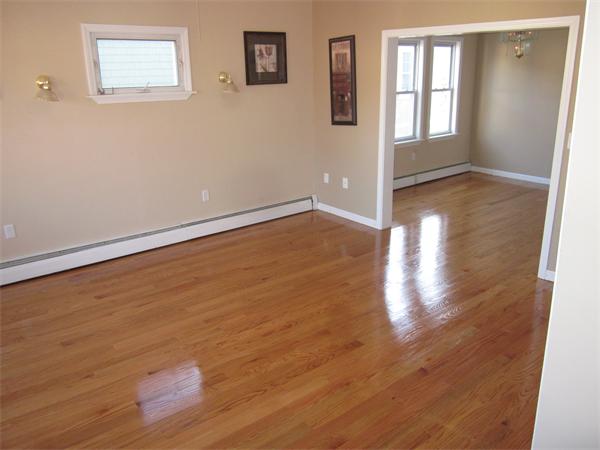 93 Rossmore Road, Unit 3 Boston, MA 02130 - Photo 8 of 11 an empty room with wooden floor and windows