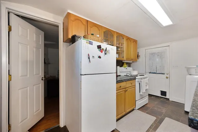 a white refrigerator freezer sitting inside of a kitchen