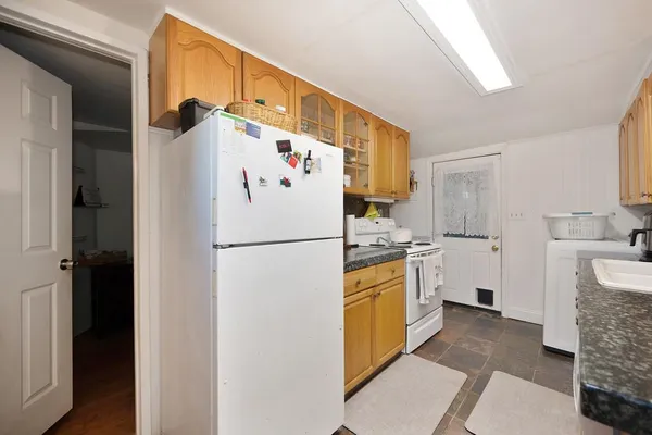 a white refrigerator freezer sitting inside of a kitchen