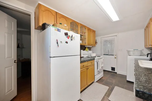 a white refrigerator freezer sitting inside of a kitchen