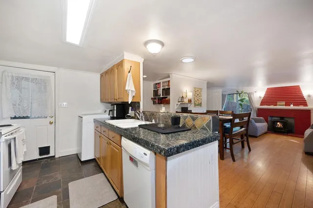 a kitchen with stainless steel appliances granite countertop a kitchen island a stove and a sink