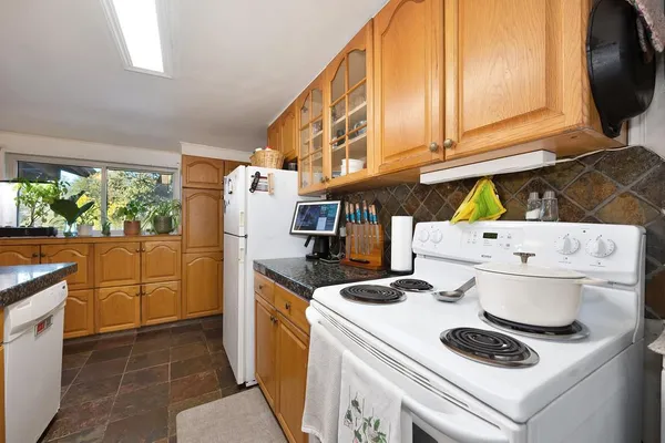 a kitchen with a stove and a refrigerator