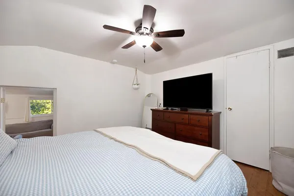 a bedroom with a bed and a flat screen tv