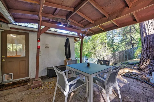a view of patio with table and chairs and potted plants