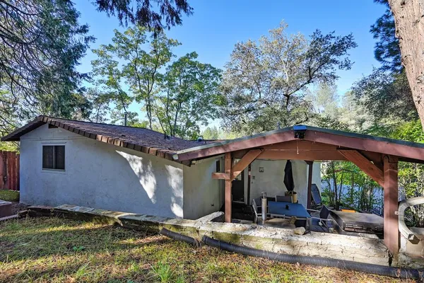 a view of a house with backyard porch and sitting area