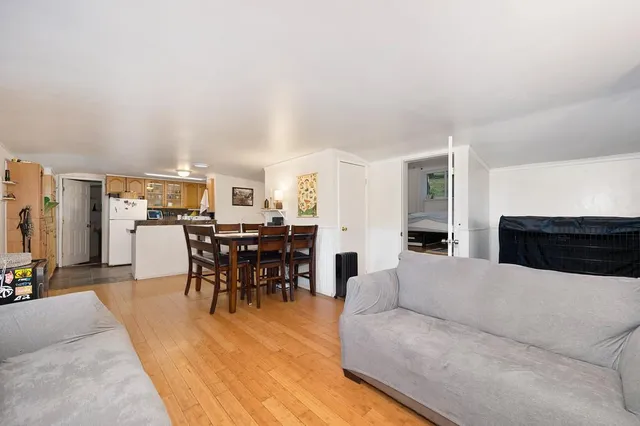 a living room with furniture a view of dining room and kitchen view