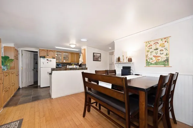 a view of a dining room with furniture and a kitchen
