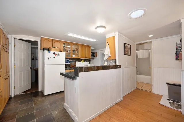 a kitchen with stainless steel appliances a refrigerator and a stove top oven