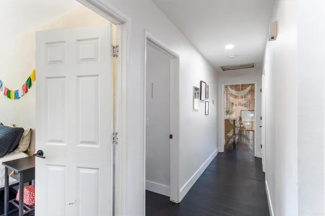 a view of hallway with livingroom and closet