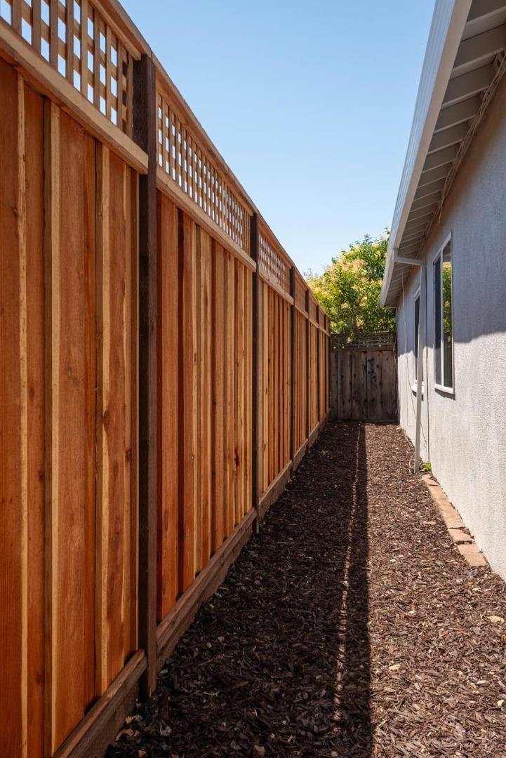 3989 Oneill Drive San Mateo, CA 94403 - Photo 27 of 47 a view of a pathway gate with wooden fence