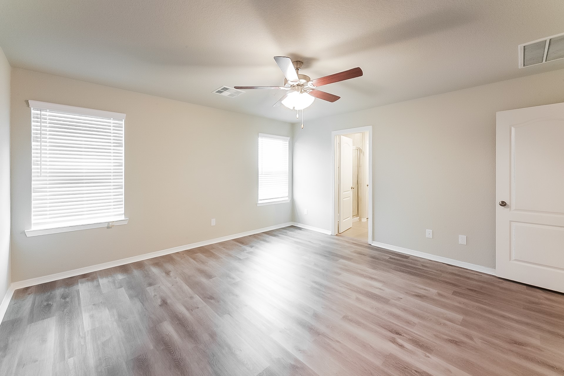 25542 Valverdant Court Porter, TX 77365 - Photo 12 of 17 an empty room with wooden floor window and ceiling fan