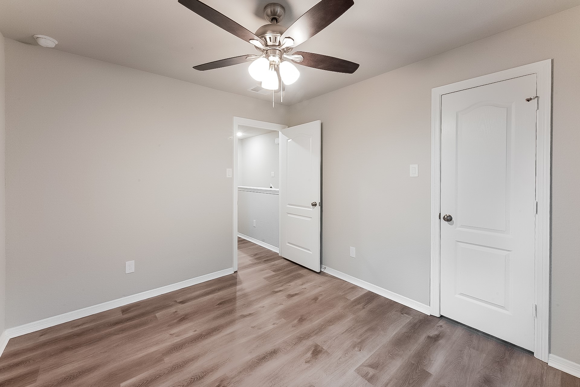 25542 Valverdant Court Porter, TX 77365 - Photo 15 of 17 an empty room with wooden floor and ceiling fan