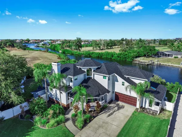 a view of a garden with plants and large trees